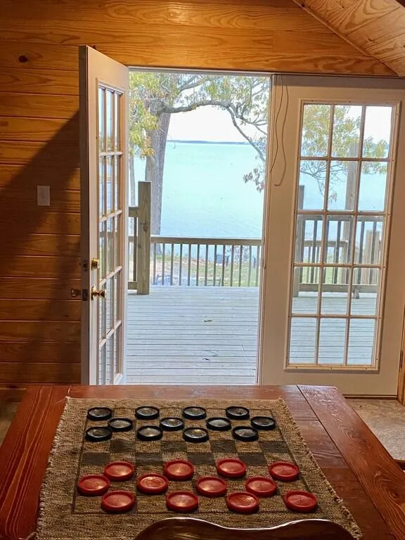 2nd floor loft with game table and a beautiful view of the lake.